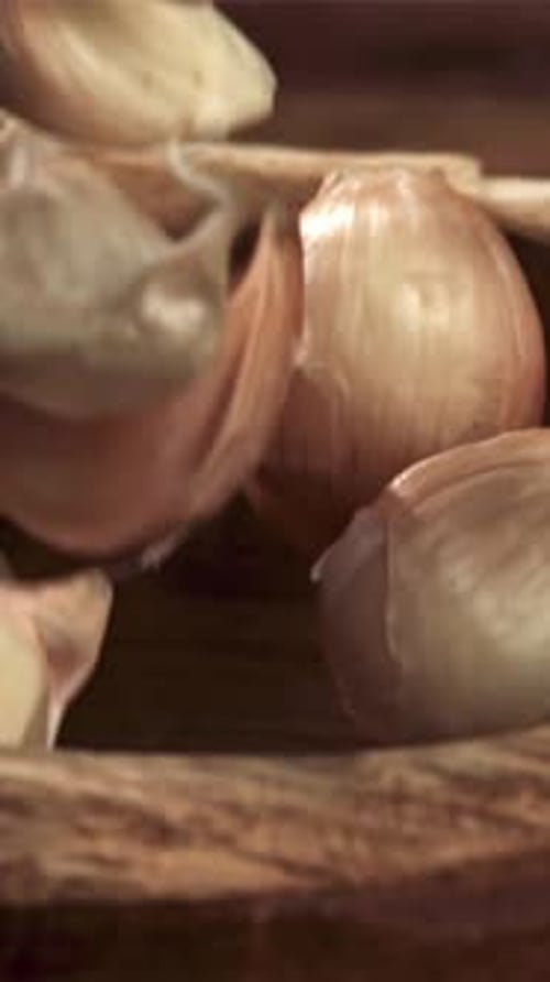 Garlic Falls Into a Wooden Plate Filmed on a Highspeed Camera at 1000 Fps