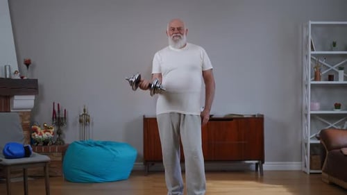 Senior Man Lifting Dumbbell in Living Room