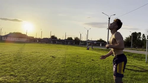 Two Sportsmen Showing Tricks with Ball While Passing It to Each Other at Field Young Men Kicking
