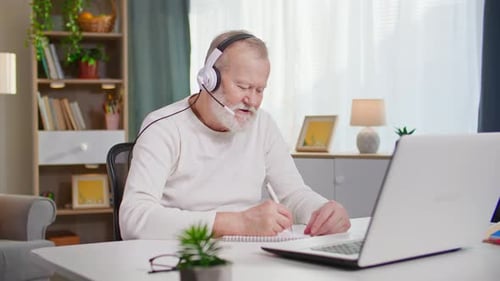 Senior Man Working at Home on Laptop