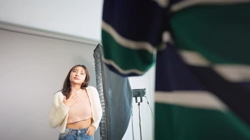 Asian beautiful woman model and cameraman working in photography studio.