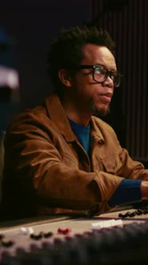 Vertical Video Music Producer Using Audio Mixer in Professional Studio