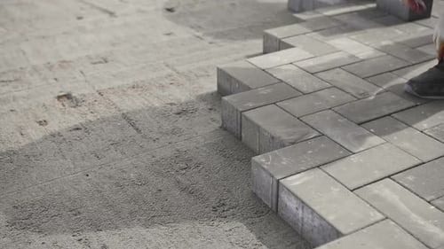 Worker Lays New Paving Slabs