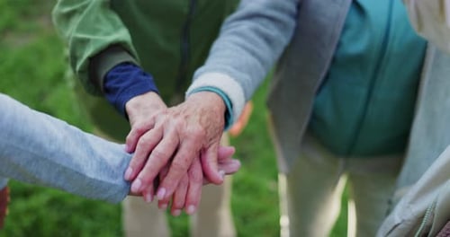 Elderly people, hands together and teamwork for community, trust or support together in nature