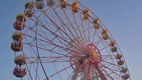 Ferris Wheel Rotating Spinning In The Amusement Park