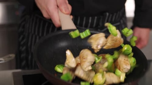 The chef prepares chicken in the kitchen. delicious lunch menu idea for a hotel grande cuisine