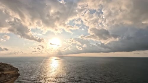 Timelapse Fluffy Cumulus Clouds Moving in Bright Sunset Sky Over Calm Sea Abstract Aerial Nature