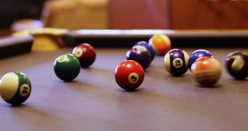 Colorful Billiard Balls Rolling On The Pool Table - close up