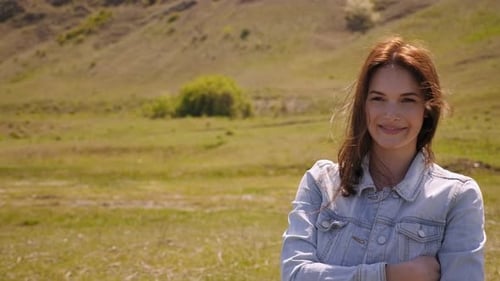 Young Woman Posing in Rural Field on Sunny Day