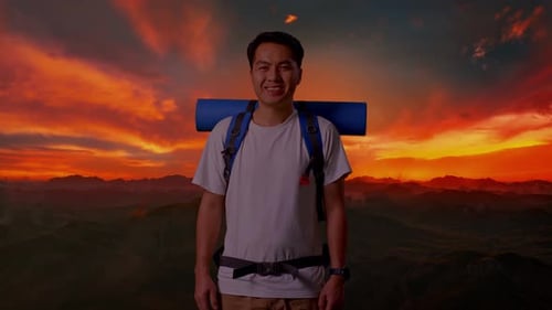 Asian Male Smiling To Camera On Top Mountain