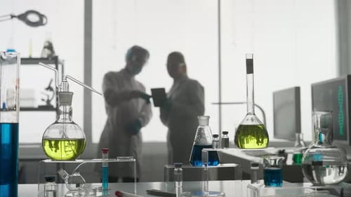 Modern Medical Research Laboratory Two Scientists Working Together Using a Tablet Analyzing