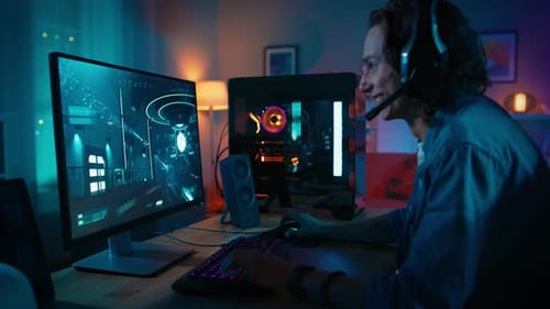 Man Plays First-Person Shooter Video Game at Desk