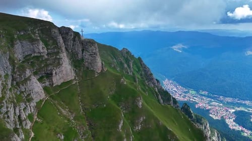 Aerial View of Green Mountain Range and Distant City