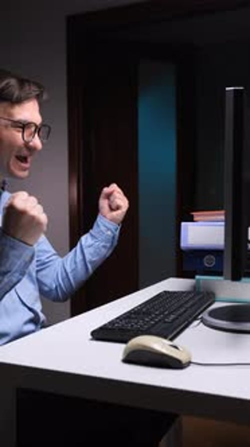Vertical Video Excited Office Worker Celebrating Success at Computer Desk