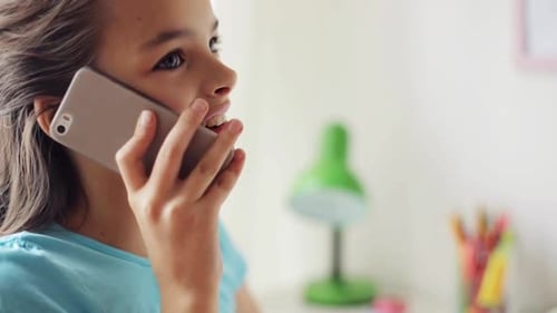 Smiling Girl Chatting on Smartphone in Bright Room