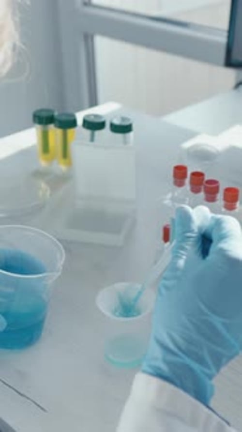 Researcher Working in Lab Mixing Chemical Compounds