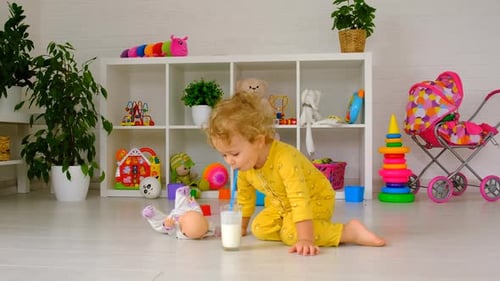 Child Drinking Milk in Playroom with Toys