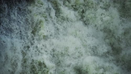 Waterfall cascade, 120fps slow-mo. Tracking shot downstream with gushing water and mist in the Nile
