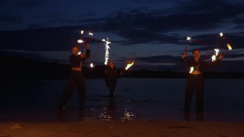 Professional Circus Performers Performing Tricks With Fire On Beach In Night Amazing Fire Show