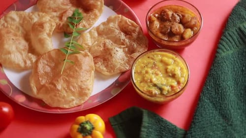 rotation Chole Bhature or Chick pea curry and Fried Puri served in terracotta crockery over backgro