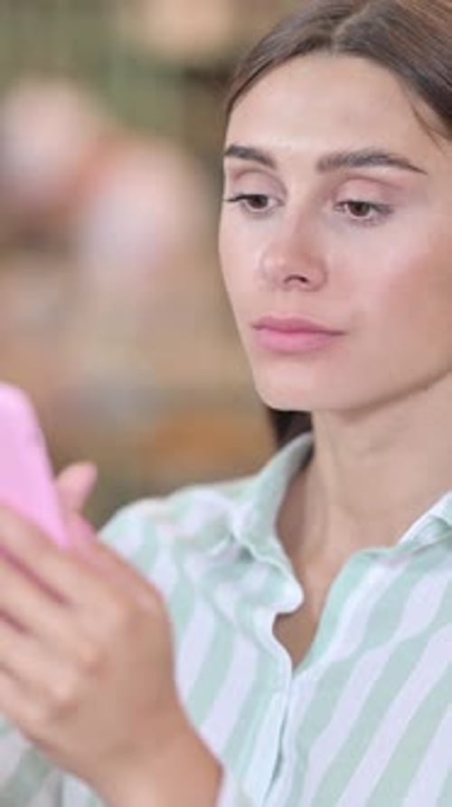 Portrait of Young Latin Woman using Smartphone, vertical video
