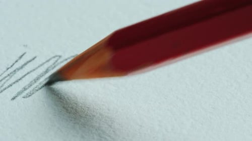 Red Pencil Drawing Lines on White Paper
