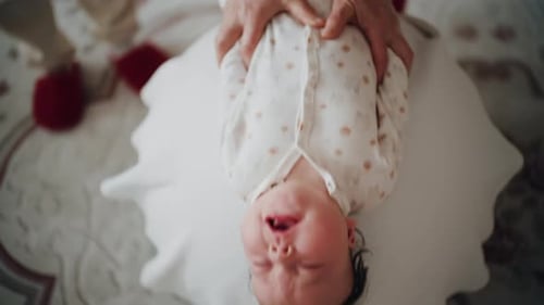 Crying Baby Gets Comfortable Massage Indoors at Home