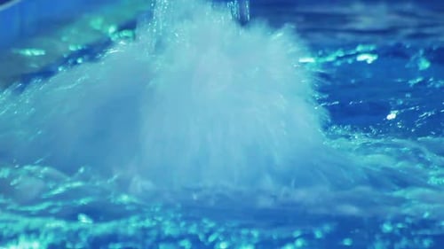 Water Splashes in Jacuzzi. Rippled Water in Blue Swimming Pool. Transparent Water