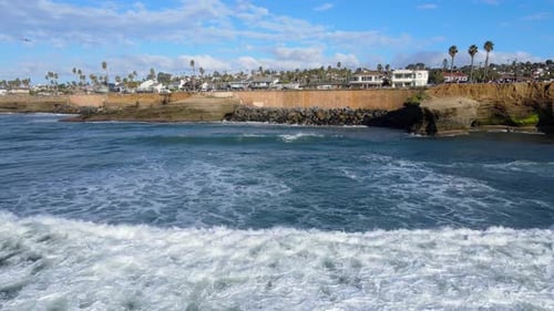Pacific Ocean waves flowing towards Sunset Cliffs area of San Diego, aerial view