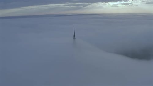 Aerial view of Mont Saint-Michel rising above clouds, France.