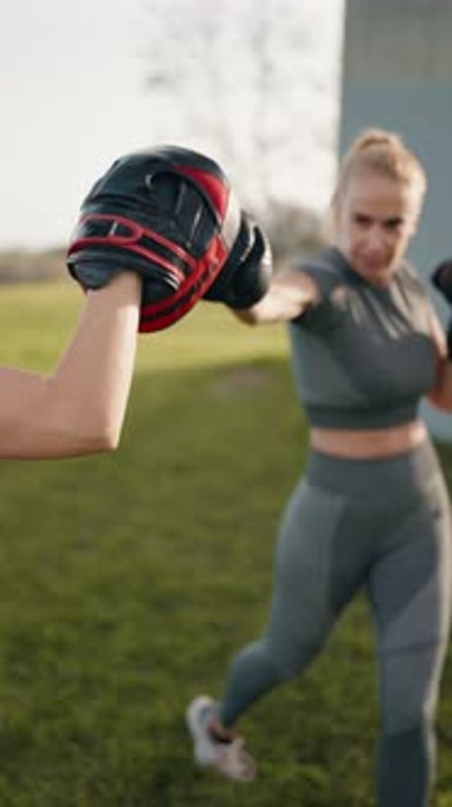 Women Boxing Outdoors in Activewear Daytime Vertical