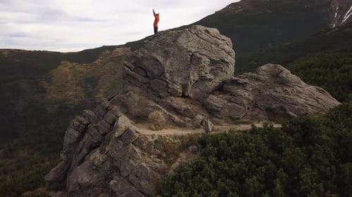 Aerial View of a Hiker Man Climbing Big Rock in Mountains