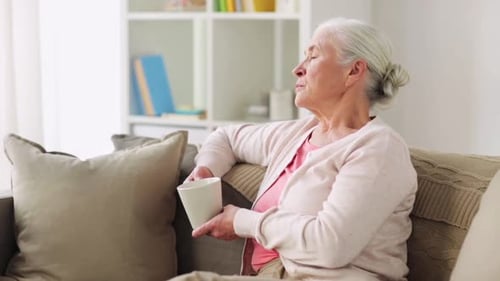 Senior Woman Relaxing With Coffee at Home