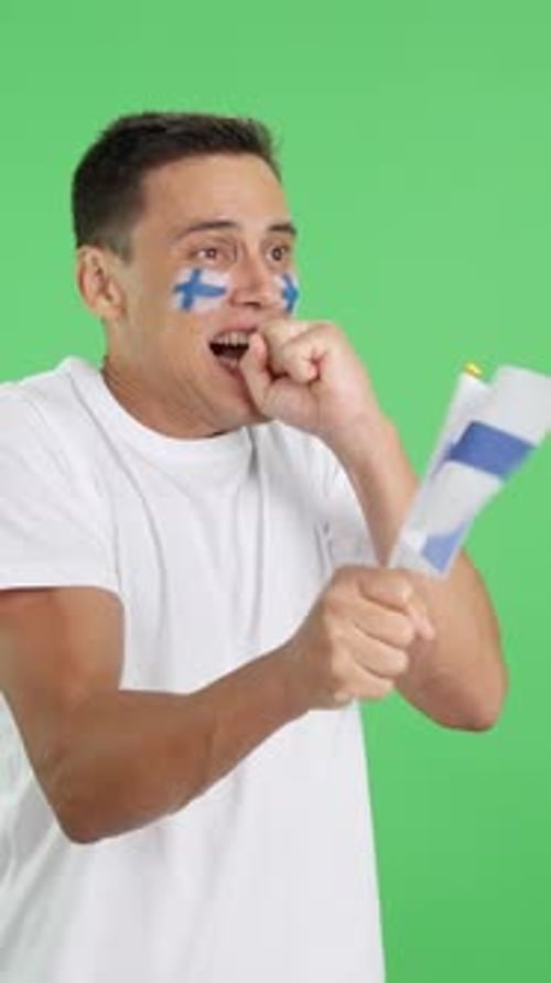 Nervous Man Cheering for Finland During a Match Looking Away