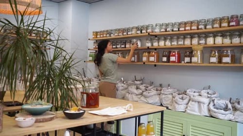 Woman selecting bulk products in an organic store