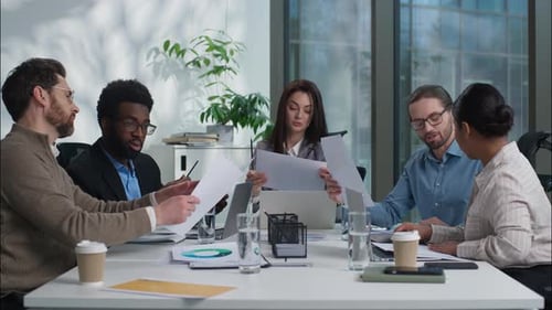 Business team collaborating on project at conference table