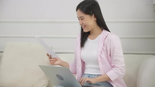 Young Woman Working on Laptop at Home