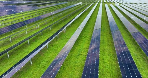 Aerial View of Solar Panel Field on Sunny Day