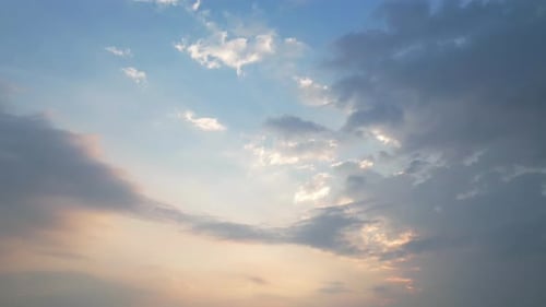 Cloudy sunset. The interplay between grey, blue, and orange creates a mesmerizing blend of cool and