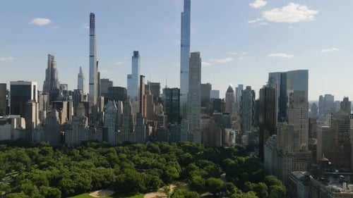 Drone flying toward skyscrapers in Midtown, Manhattan, sunny day in New York
