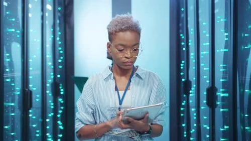 Woman Working on Tablet in Data Server Room