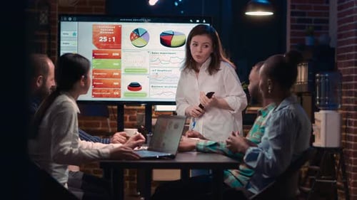 Data Presentation by Woman to Colleagues in Office