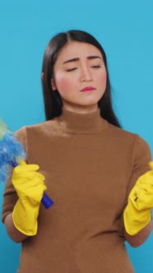 Woman with Duster Looks Displeased and then Smiles