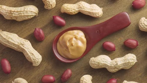 Creamy Peanut Butter and Raw Peanuts Still Life