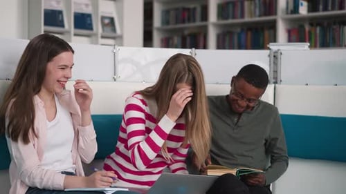 Friends with Laptop Laugh in Library