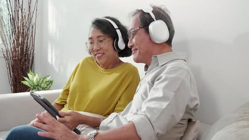 Relaxed Senior Couple Listening to Music at Home