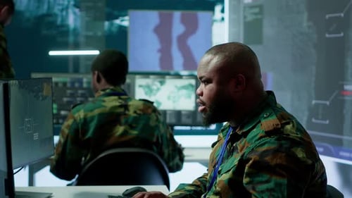 Military Team in a Control Center Uses Advanced Technology to Gather Information
