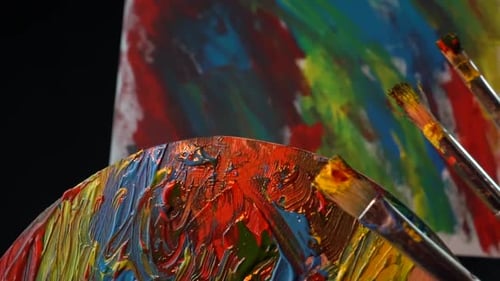 Paint Palette with Brushes and Colorful Canvas