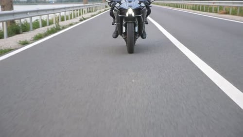 Front View to Biker Riding on Modern Sport Motorbike at Countryside Way Young Motorcyclist Racing
