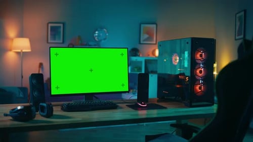 Powerful Personal Computer Gamer Rig with Mock Up Green Screen Monitor Stands on the Table at Home.